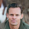 Testimonials man wearing green jacket avatar